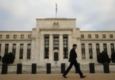 A man walks past the Federal Reserve in Washington